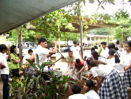 2008 Students filling plastic bottles with soil to set up container gardening